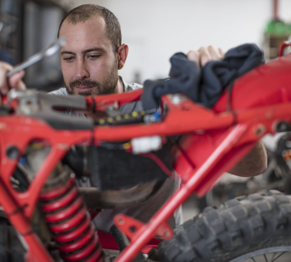 Mechanic working on motorcycle in workshop